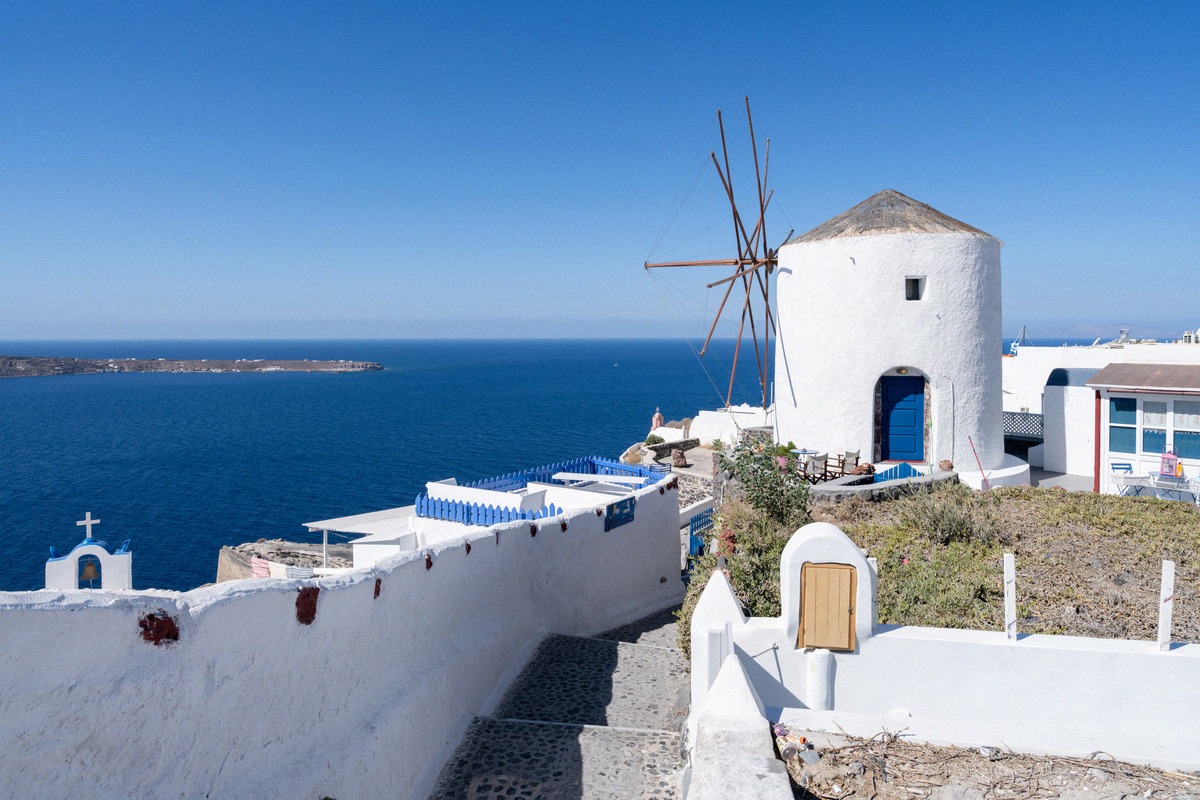 White windmill above the blue sea in Oia on Santorini
